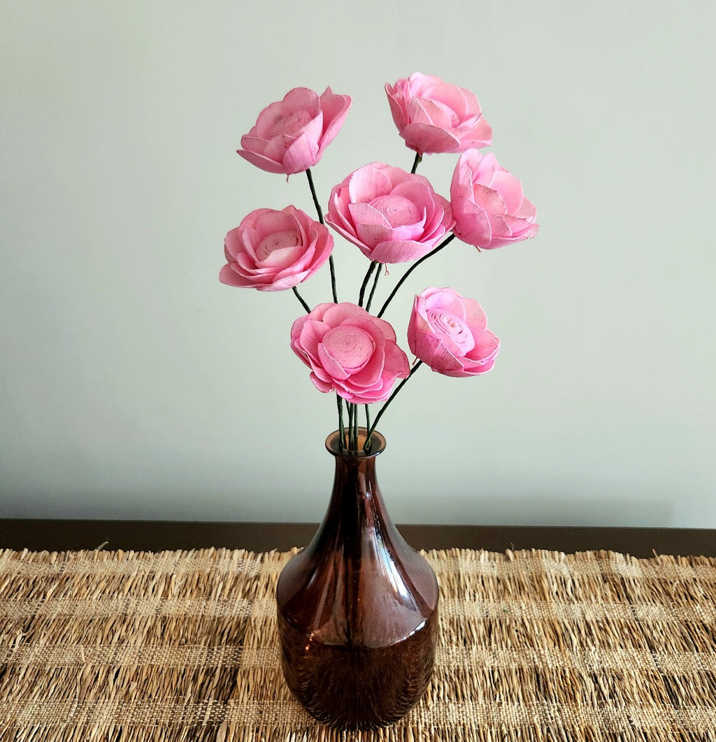 Pink sola wood roses in a vase for table decor