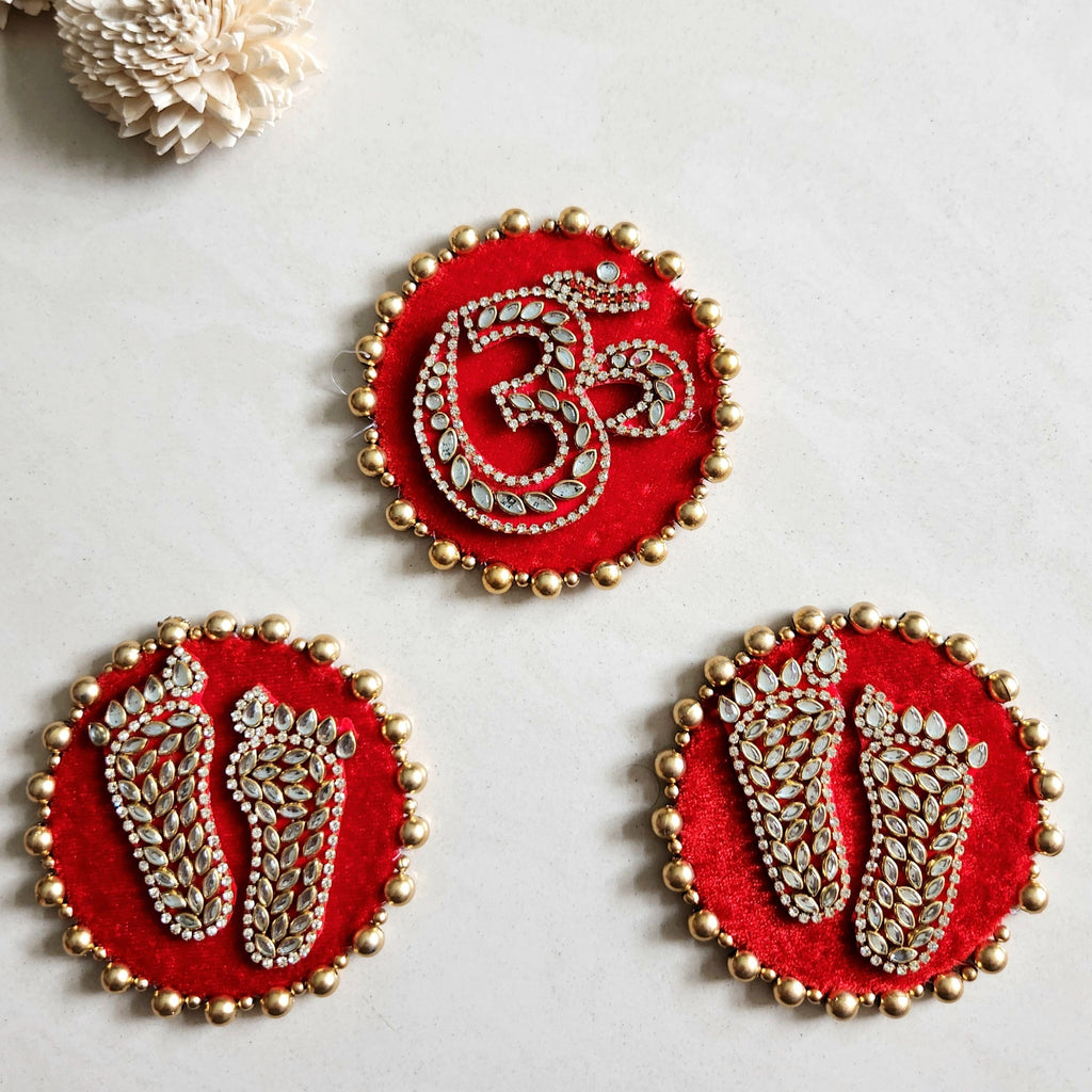 Three red embroidered Laxmi charan and Om stickers with gold detailing for Pooja decoration